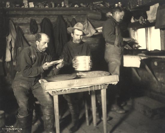 Sifting black sand from the gold in a cabin on Claim No. 13, 189